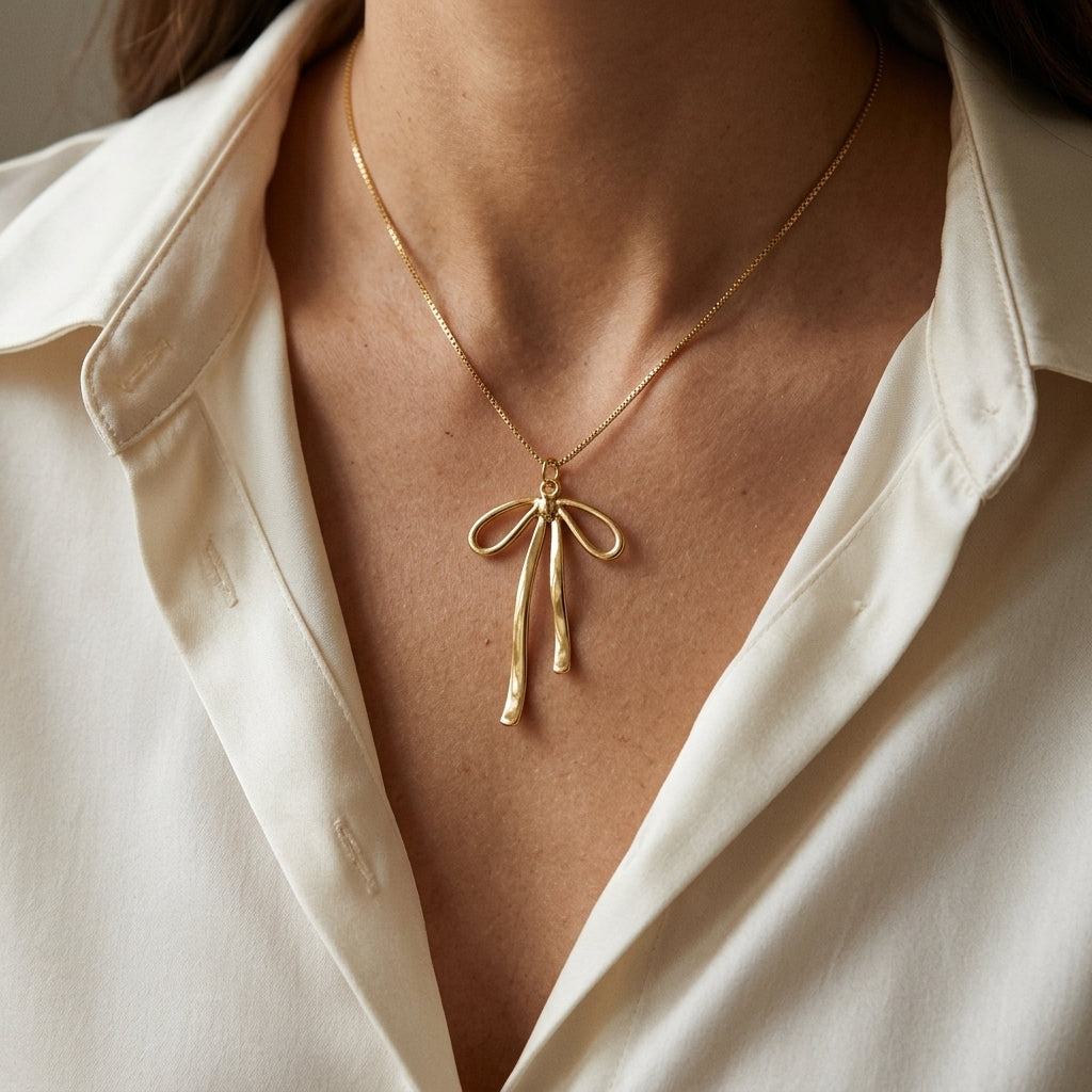 Gold-Tone Ribbon Bow Necklace — styling view